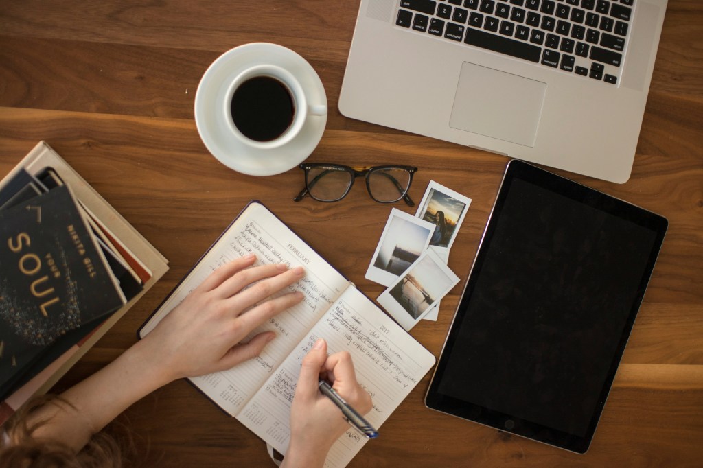 Office table with coffee and notebook